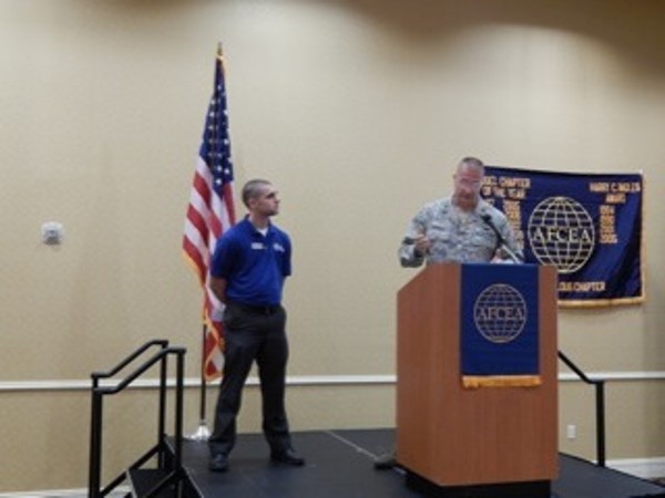 In September, Col. David Bosko, USAF, chapter president, Chapter President, presents David Rogers, a member of The Mission Continues, with a $50.00 check for the nonprofit organization, which supports post-9/11 veterans.